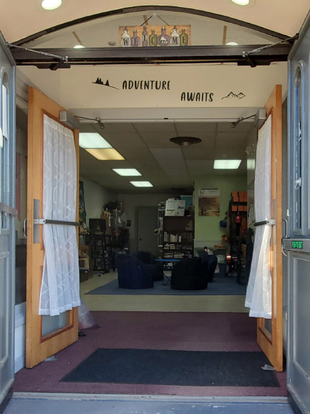 Adventure Awaits Sign above Entrance Door to base camp and teen center